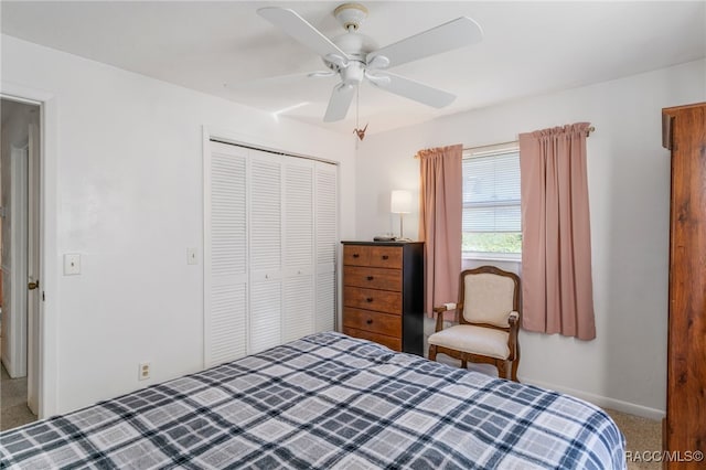 bedroom with ceiling fan, baseboards, a closet, and carpet flooring