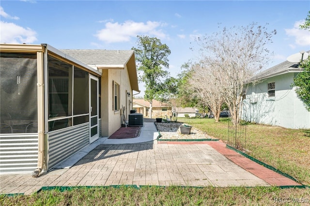 view of patio / terrace with a sunroom and central AC unit