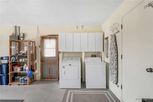 clothes washing area featuring cabinet space and washer and dryer