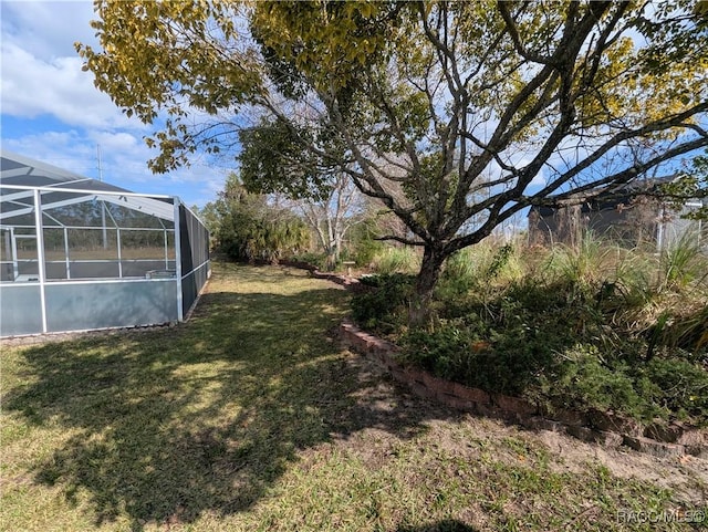 view of yard featuring glass enclosure