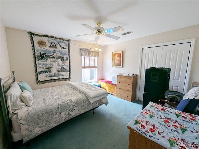 carpeted bedroom featuring ceiling fan and a closet