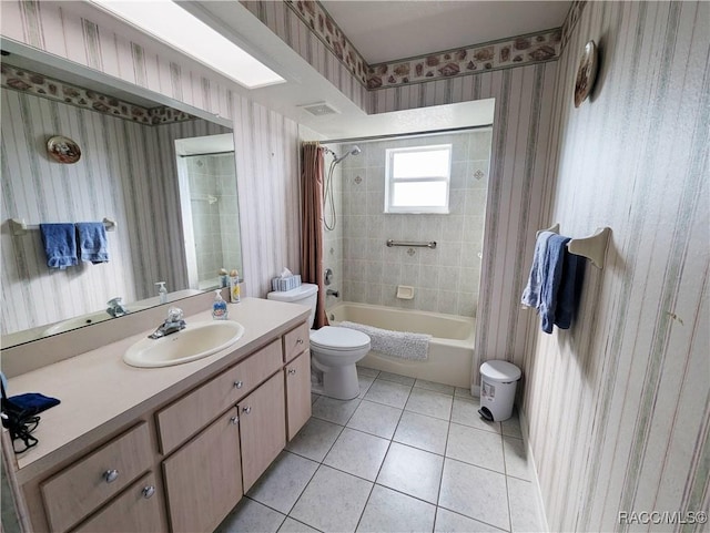 full bathroom with shower / tub combo with curtain, tile patterned floors, toilet, and vanity