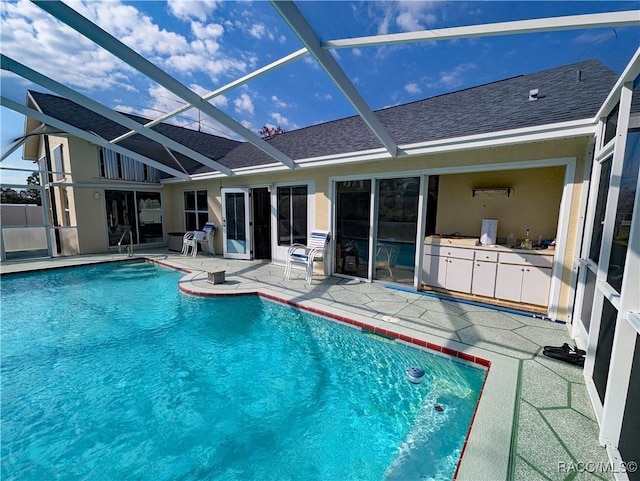 view of swimming pool with a lanai and a patio