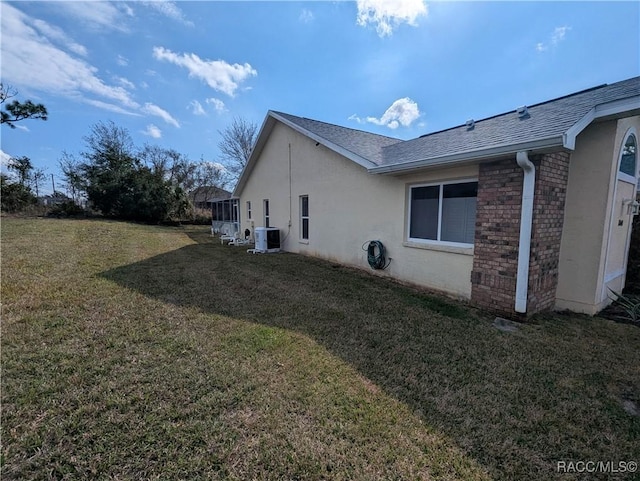 view of property exterior with cooling unit and a yard