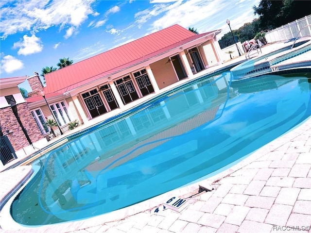 view of swimming pool featuring a patio area