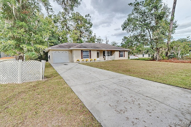 ranch-style home with a garage and a front lawn