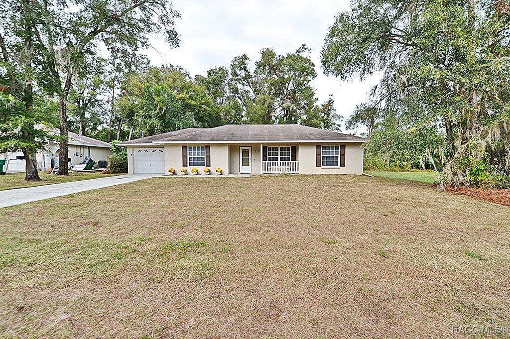 ranch-style home featuring a front yard and a garage