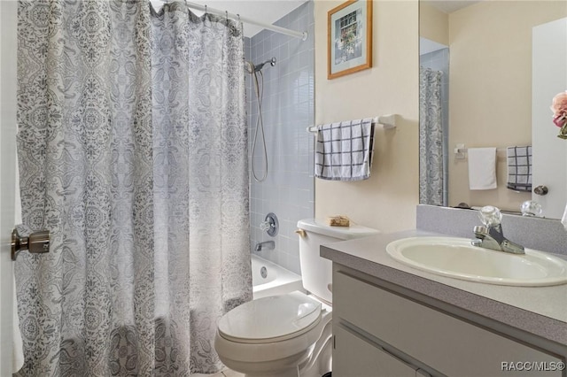 full bathroom featuring vanity, shower / tub combo with curtain, and toilet