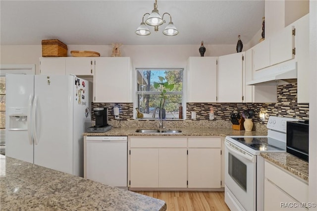 kitchen featuring sink, light stone counters, pendant lighting, white appliances, and white cabinets