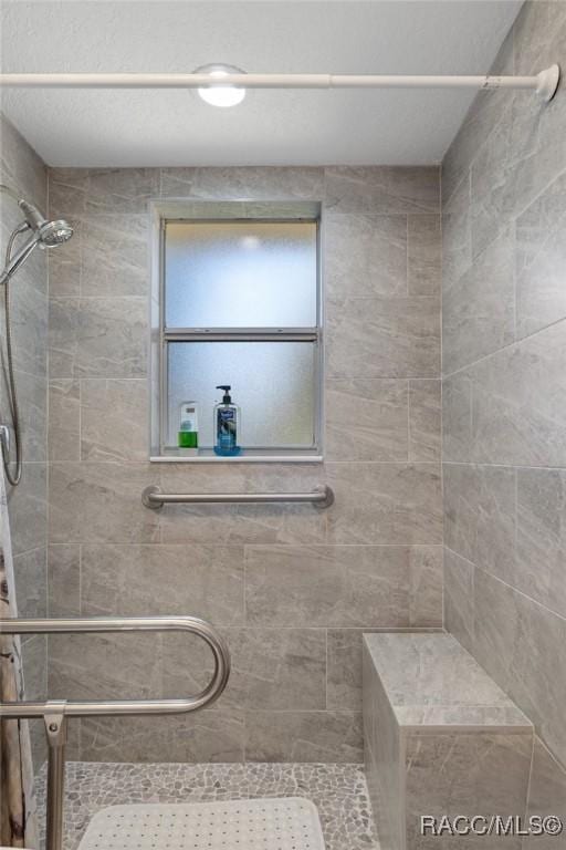 bathroom with a tile shower