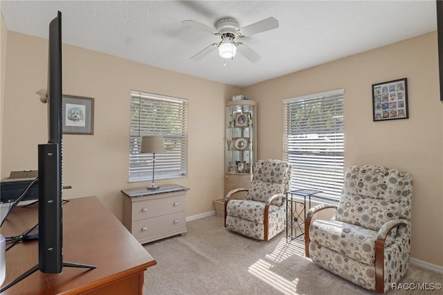 carpeted office with ceiling fan and a healthy amount of sunlight