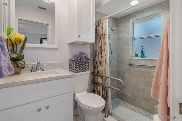 bathroom with vanity, toilet, and a shower with shower curtain