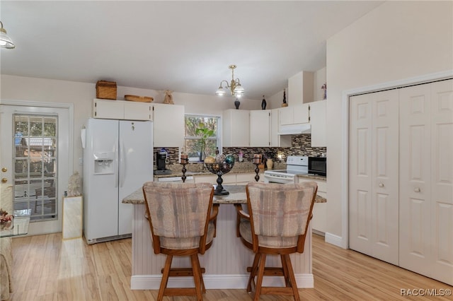 kitchen featuring pendant lighting, white appliances, white cabinetry, and light wood-type flooring