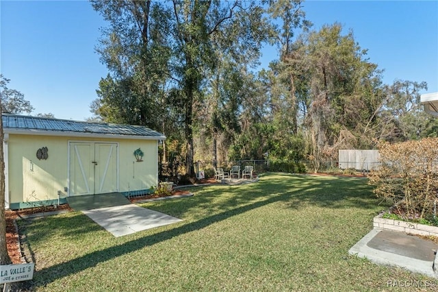 view of yard featuring a patio area and a storage unit