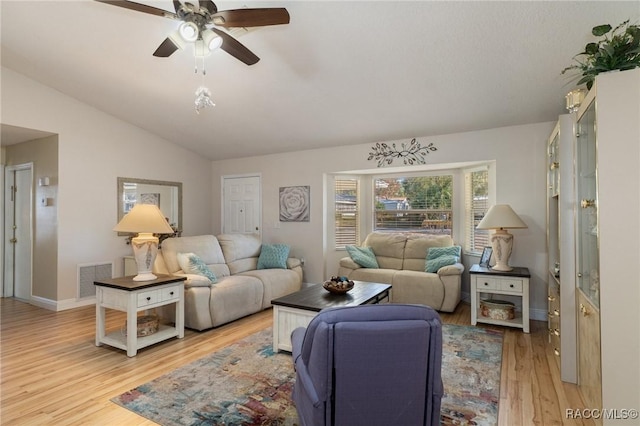 living room with lofted ceiling, ceiling fan, and light hardwood / wood-style flooring