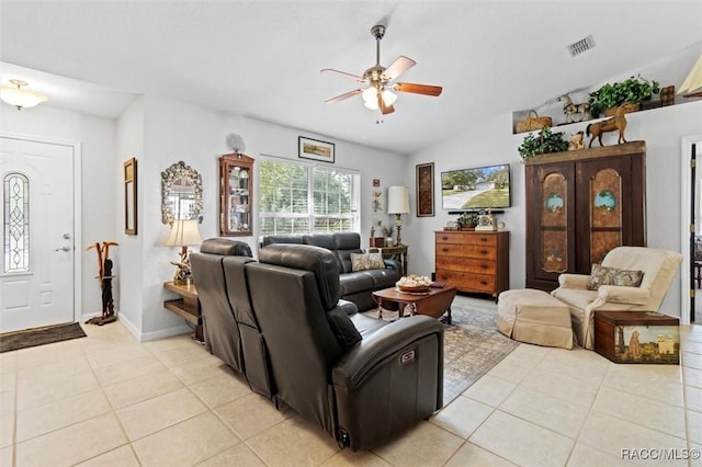 tiled living room featuring ceiling fan and lofted ceiling