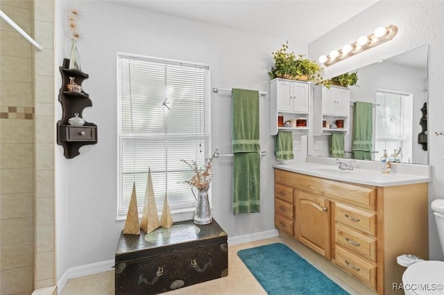 bathroom featuring tile patterned flooring, vanity, and toilet