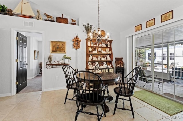 dining space featuring a notable chandelier and light tile patterned floors