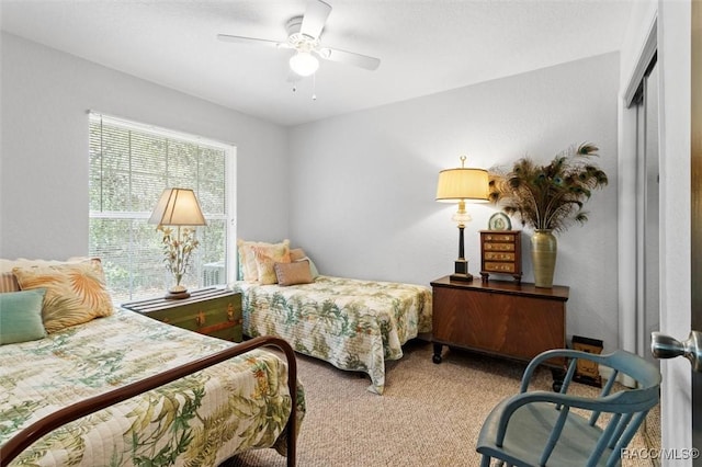 carpeted bedroom with a closet and ceiling fan