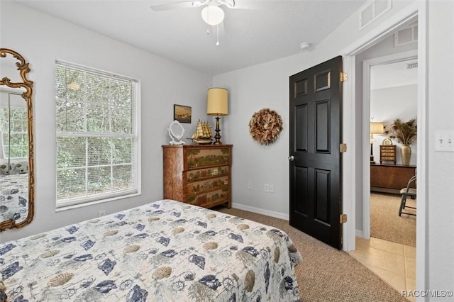 bedroom with ceiling fan and light colored carpet