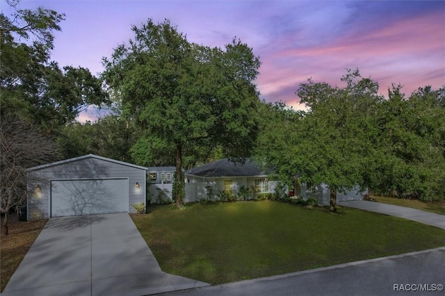 view of front of home featuring a garage and a lawn