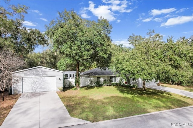 ranch-style house featuring a garage and a front lawn