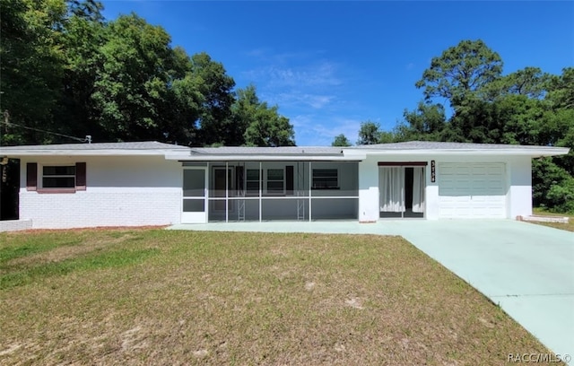 single story home with a front yard and a garage