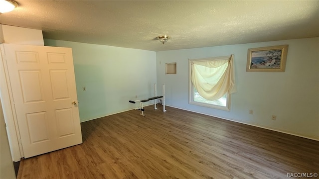 washroom with dark hardwood / wood-style flooring and a textured ceiling