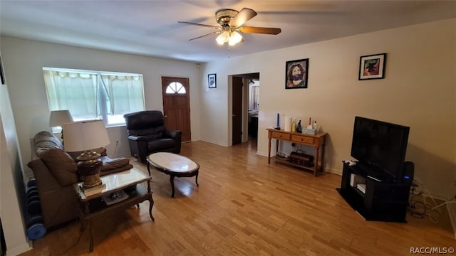 living room with ceiling fan and light hardwood / wood-style floors