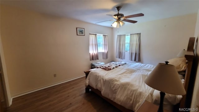 bedroom with ceiling fan and dark hardwood / wood-style floors