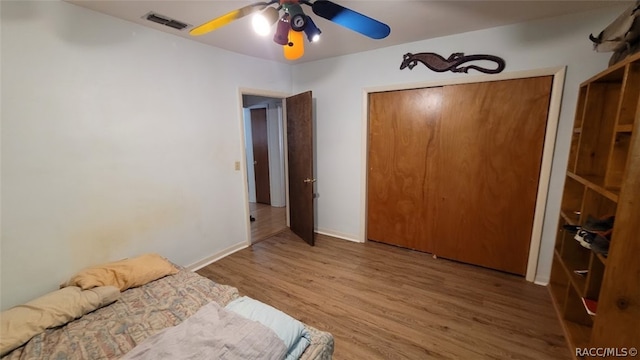 unfurnished bedroom featuring a closet, ceiling fan, and hardwood / wood-style floors