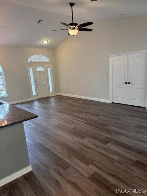 foyer with ceiling fan, lofted ceiling, and dark hardwood / wood-style flooring