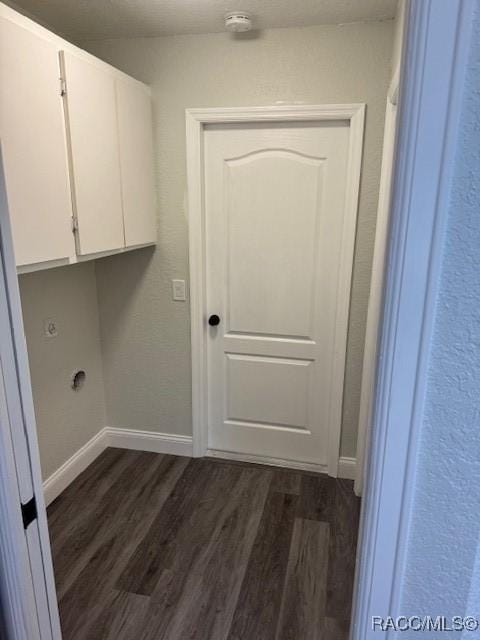 clothes washing area with cabinets and dark hardwood / wood-style flooring