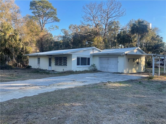 single story home featuring a garage and a front lawn