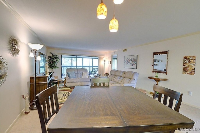 tiled dining space featuring crown molding