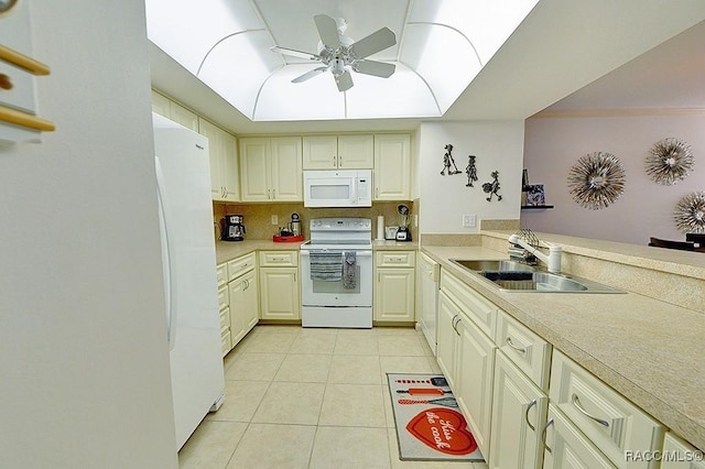 kitchen with white appliances, sink, tasteful backsplash, light tile patterned flooring, and kitchen peninsula