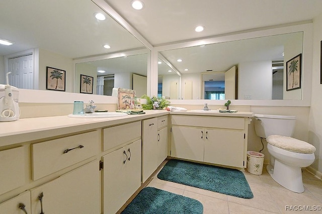 bathroom with tile patterned floors, vanity, and toilet