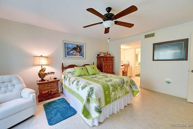 tiled bedroom with ensuite bath and ceiling fan