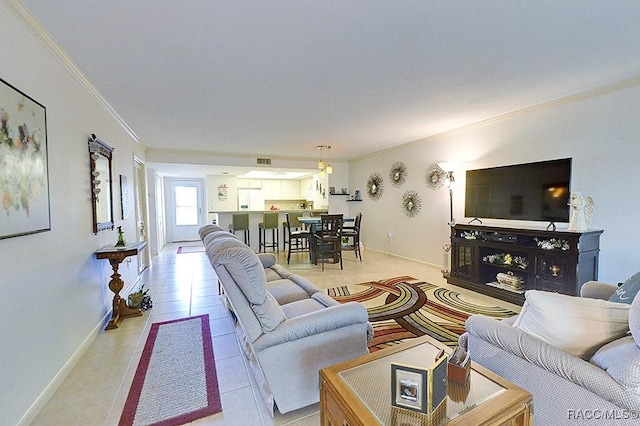 living room featuring light tile patterned floors and crown molding