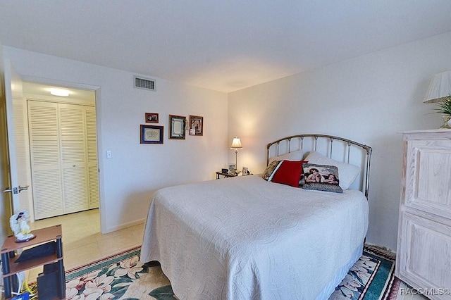 bedroom featuring light tile patterned flooring and a closet