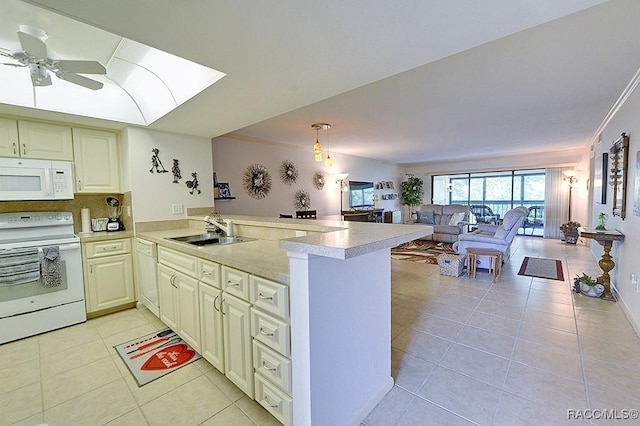 kitchen with kitchen peninsula, pendant lighting, white appliances, and sink