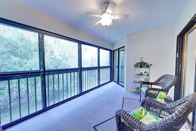 sunroom featuring ceiling fan and vaulted ceiling