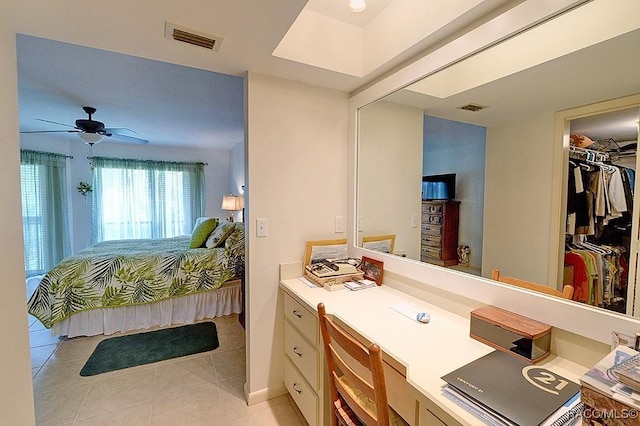 bedroom featuring a walk in closet, a closet, ceiling fan, and light tile patterned flooring