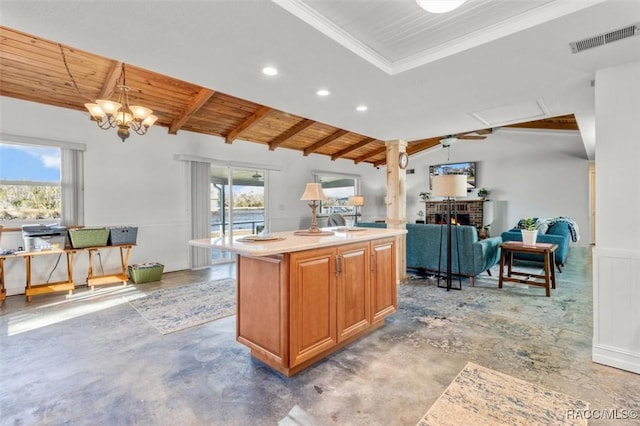 kitchen featuring wood ceiling, a center island with sink, a brick fireplace, vaulted ceiling with beams, and pendant lighting