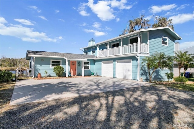 view of property with a garage and a balcony