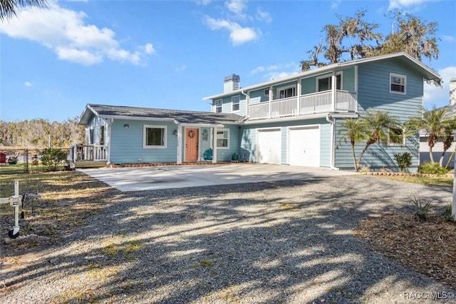 view of property featuring a balcony and a garage