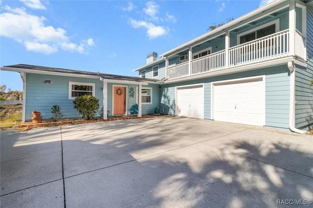 front of property with a balcony and a garage