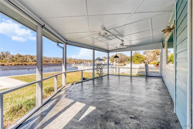 unfurnished sunroom with ceiling fan and a healthy amount of sunlight