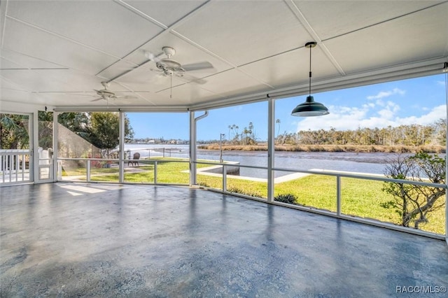 unfurnished sunroom with ceiling fan and a water view