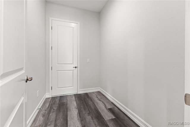 corridor featuring dark hardwood / wood-style flooring